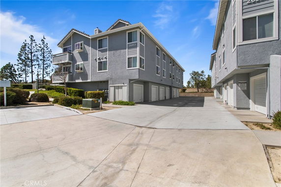 Front view of a multi-story building with garage doors at ground level.