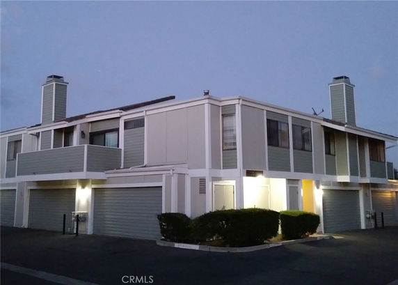 Front view of a two-story building with multiple garages.