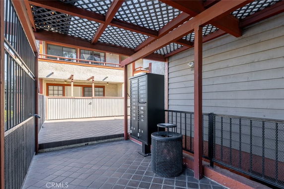 View of a building with a covered walkway and mailbox area.