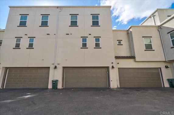 Front view of a two-story building with multiple garage doors.