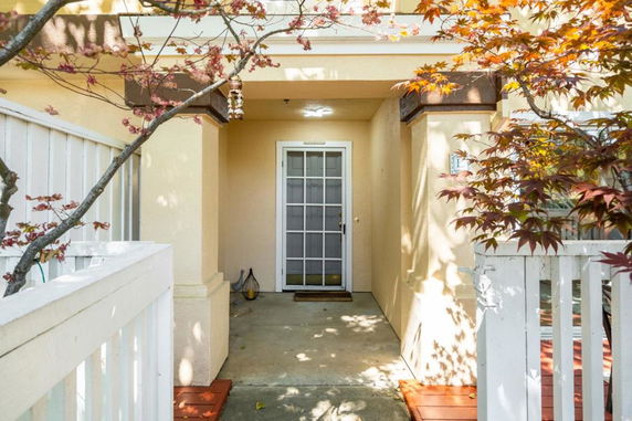 Front view of a house entrance with a glass-paned door and a small porch area.