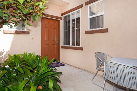 Front view of a house with a single door and window.