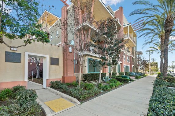 Front view of a multi-story residential building with balconies.