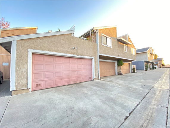 Front view of a multi-story house with multiple garage doors.