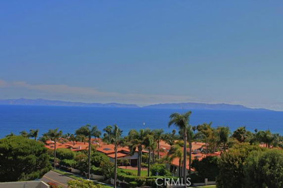 Panoramic view of rooftops and ocean in the background.