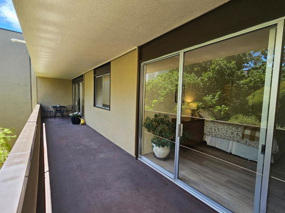 View of a balcony with sliding glass doors.