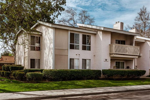 Front view of a two-story residential building with balconies.