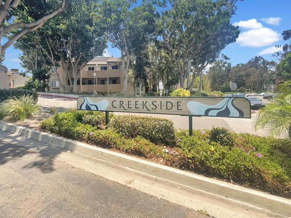 Front view of a residential building with a sign reading 'Creekside'.