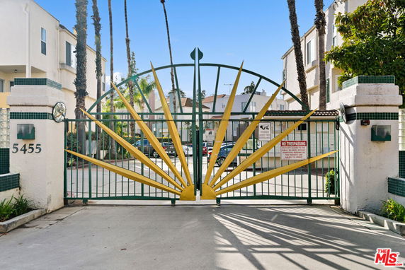 Front view of a residential building with a decorative gate.