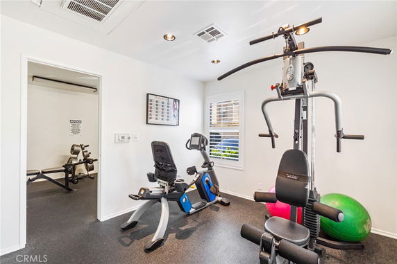 Indoor gym area with exercise equipment including a stationary bike and multi-gym machine.