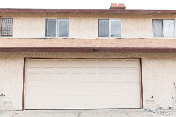 Front view of a two-story house with a large garage door.