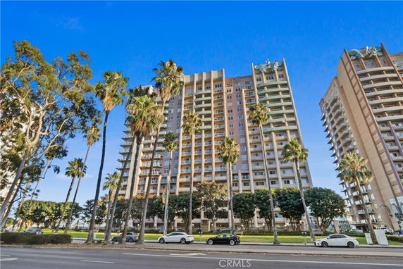 Front view of a tall apartment building with balconies.