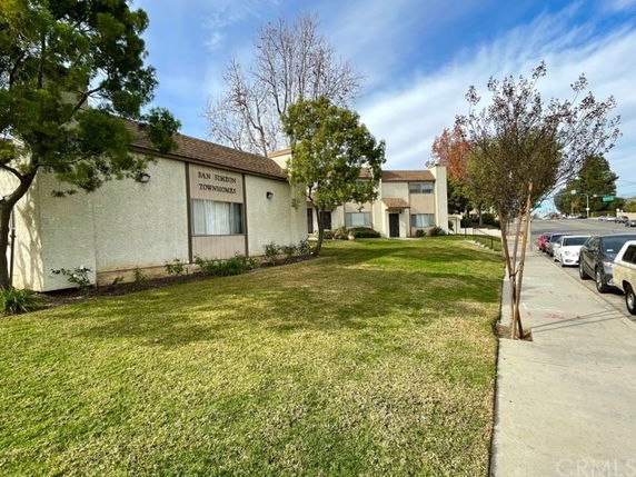 Front view of a multi-story townhouse building labeled San Simeon Townhomes.