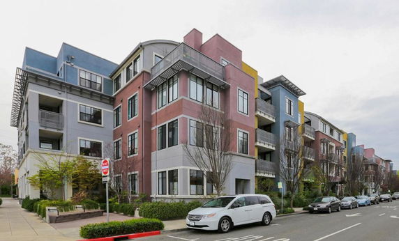 Front view of a multi-story apartment building with modern design.