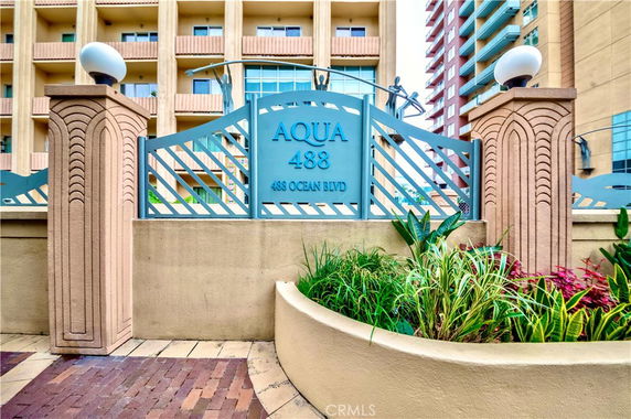 Front view of a multi-story building with decorative entrance and signage.