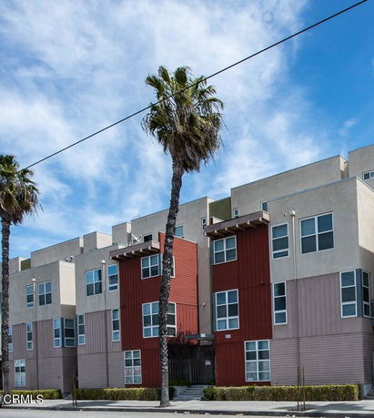 Front view of a modern, multi-story apartment building.