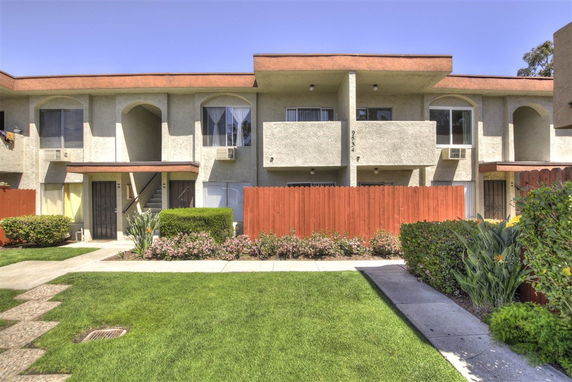 Front view of a residential building with a two-story design and balconies.