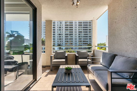 Covered outdoor seating area with view of high-rise building