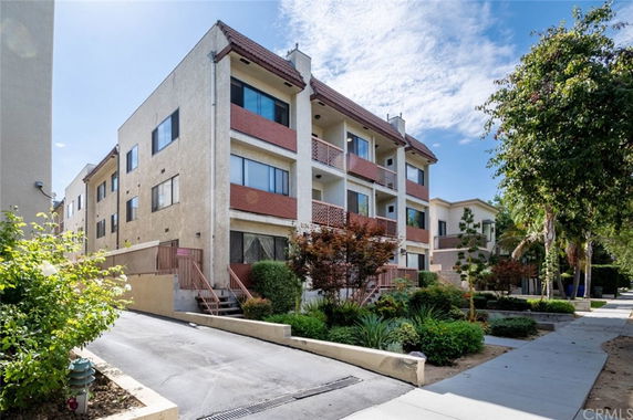 Front view of a multi-story apartment building with balconies
