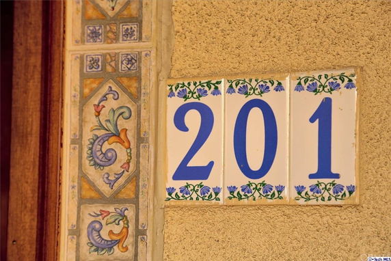 House number 201 displayed on decorative tiles.