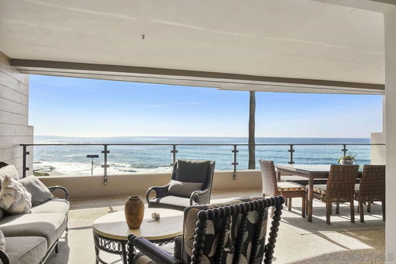 Balcony with seating area overlooking the ocean.
