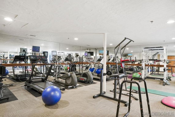 Interior view of a gym with various exercise equipment.