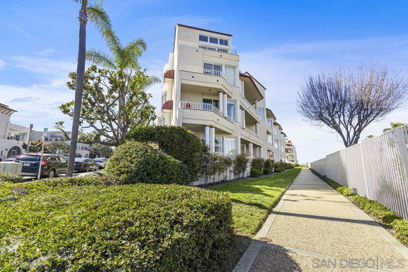 Front view of a multi-story residential building with balconies.