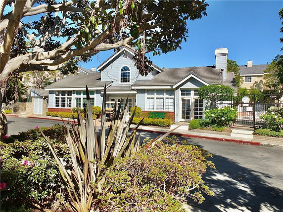 Front view of a house with multiple large windows and a gabled roof.