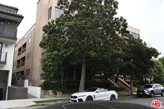 Front view of a multi-story residential building with balconies.