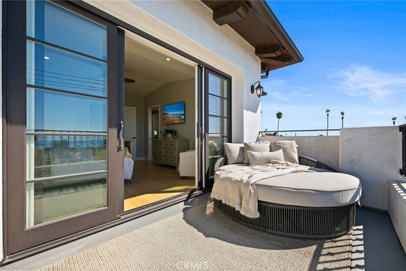 Balcony with seating area and ocean view.