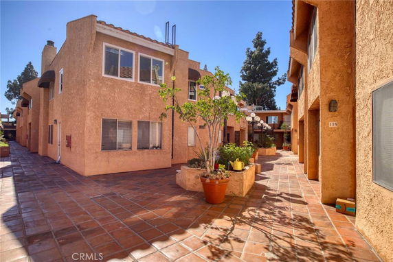 Front view of a multi-story house with a courtyard.