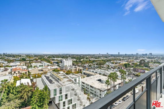 Panoramic view of cityscape from a high vantage point, showing numerous buildings and urban landscape.