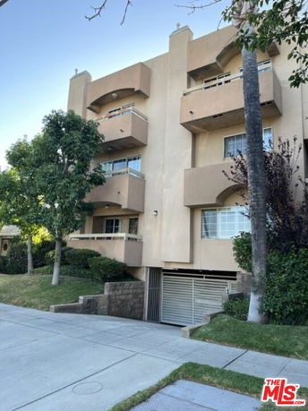 Front view of a multi-story residential building with balconies.