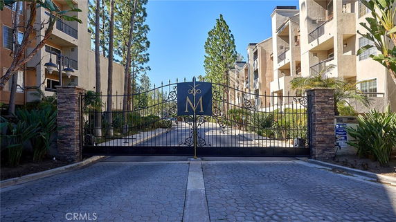 Front view of an apartment complex with a gated entrance.