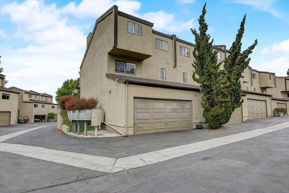 Front view of a multi-story residential building with garages.