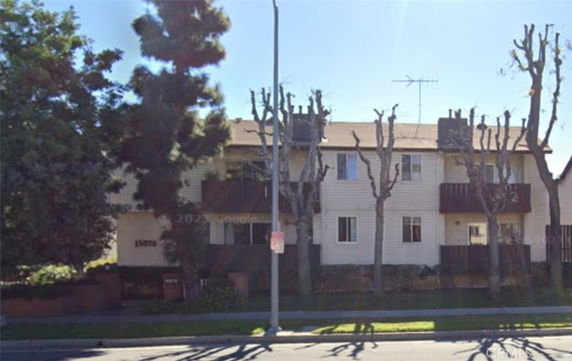 Front view of a two-story apartment building with balconies.