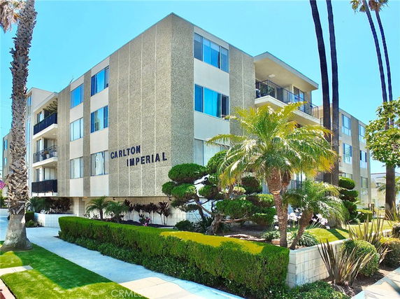 Front view of a multi-story apartment building named Carlton Imperial.