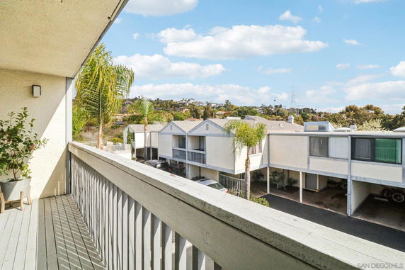 View of residential buildings with garages and palm trees in the surroundings.