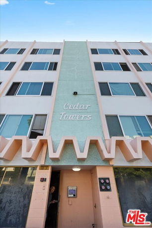 Front view of a multi-story building labeled 'Cedar Towers'.