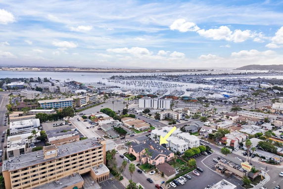 Aerial view of a coastal area with buildings and a marina.