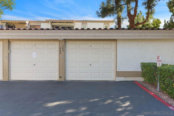 View of a two-door garage in a residential building's parking area
