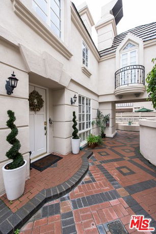 Front view of a two-story house with a decorative entryway and balcony.