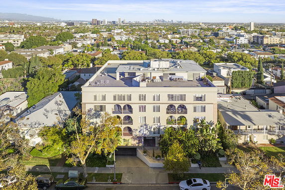 Front view of a multi-story building with balconies.