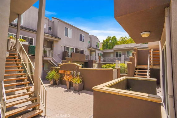 View of a multi-story apartment complex with stairs and balconies.