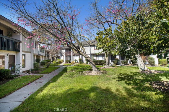 View of a residential area with row houses and green lawns.