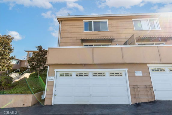 Front view of a multi-story house with a double garage.