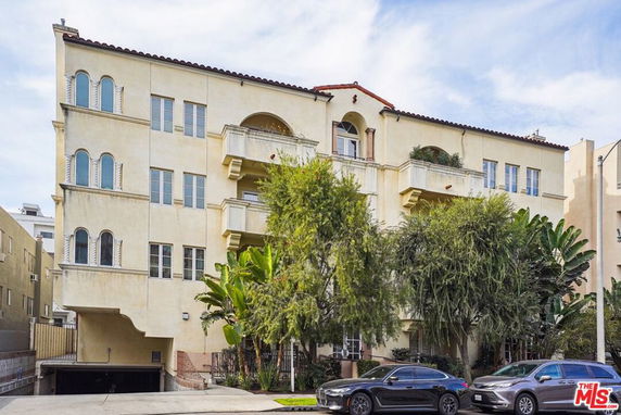 Front view of a multi-story residential building with balconies.