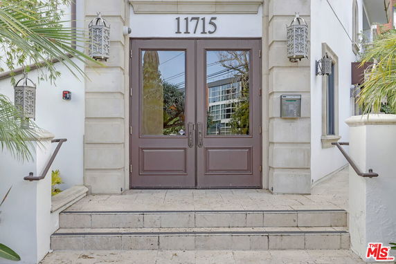 Front view of a building entrance with double doors and steps.