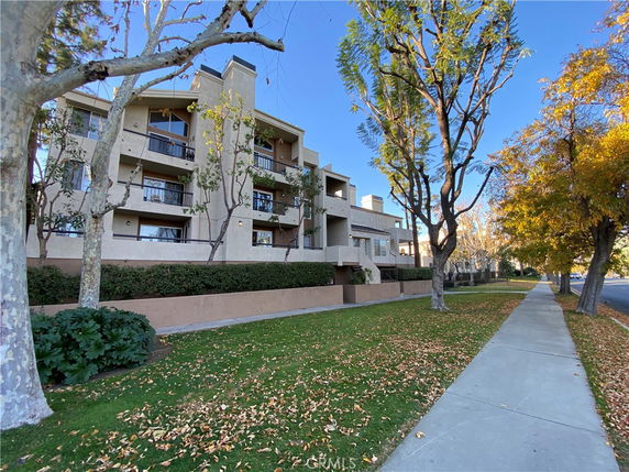 Front view of a multi-story residential building with balconies.