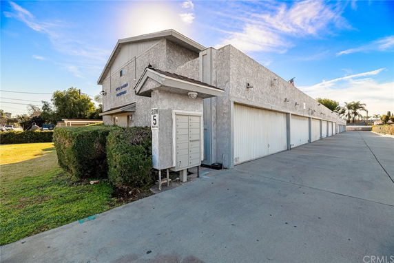 Front view of a multi-garage building exterior with driveway.